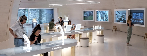 Plusieurs personnes visitent une exposition au sein du Pavillon Novartis